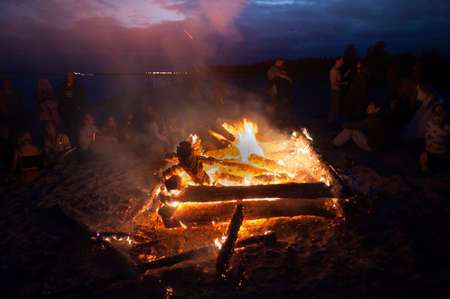 Leningrad Oblast, Russia - July 14, 2015: Big  tourist bonfire on the beach Finland Gulf during the festival. Young people dance and sing around the campfire. Deep night.のeditorial素材