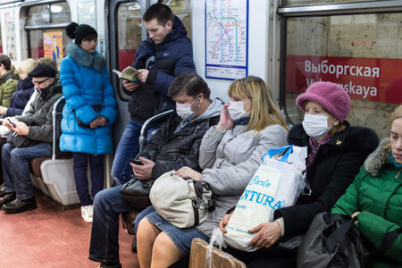 St.Petersburg, Russia - January 29, 2016: People are protected against swine flu by a gauze mask ...