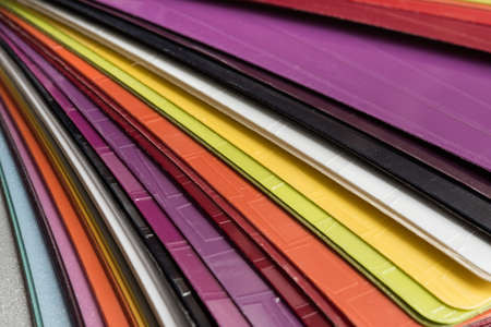 Glossy PVC plastic cards to select the color of furniture lined fan close-up on a white backgroundの写真素材