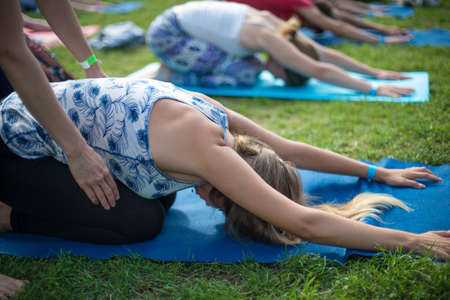 Saint-Petersburg, Russia - August 16, 2015: People doing yoga in a city park in the open air during the festival.のeditorial素材