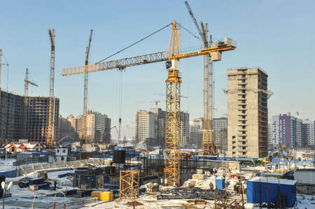 Saint-Petersburg, Russia - March 1, 2016: Construction of apartment houses of economy class. At the construction site work construction cranes.のeditorial素材