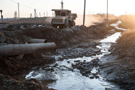 Yakutia, Russia - April 21, 2015: Large trucks take out the ground with diamond pipes in the processing enterprises in the city  Mirnyのeditorial素材