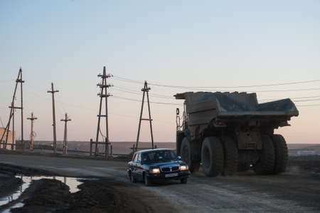 Yakutia, Russia - April 21, 2015: Large trucks take out the ground with diamond pipes in the processing enterprises in the city  Mirnyのeditorial素材