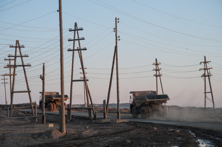 Yakutia, Russia - April 21, 2015: Large trucks take out the ground with diamond pipes in the processing enterprises in the city  Mirnyのeditorial素材