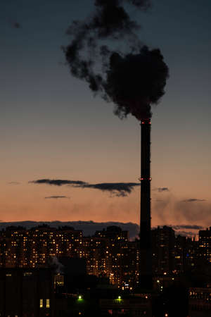 Saint-Petersburg, Russia - March 19, 2016: Black smoke from pipes on a background of CHP residential district of the city at night.のeditorial素材