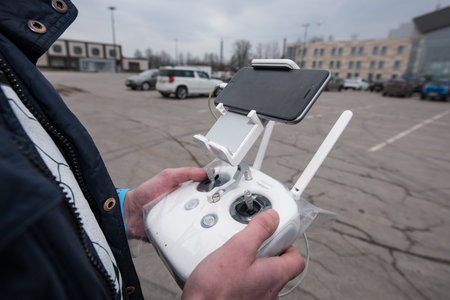 Saint-Petersburg, Russia - March 26, 2016: People learn to control unmanned aerial vehicles - drones...