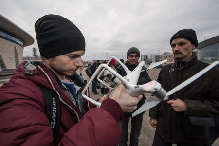 Saint-Petersburg, Russia - March 26, 2016: People learn to control unmanned aerial vehicles - drones...