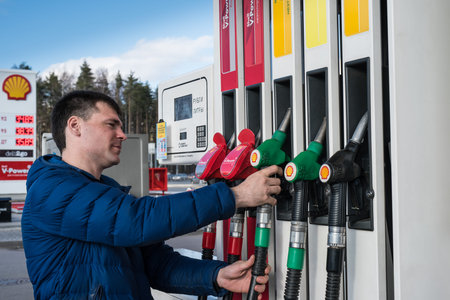 Saint-Petersburg, Russia - April 7, 2016: A man 30-35 years fills his car with petrol at a petrol...