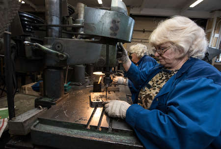 Saint-Petersburg, Russia - March 23, 2016: Women 50-55 years is working on drilling machines in the metalworking shopのeditorial素材