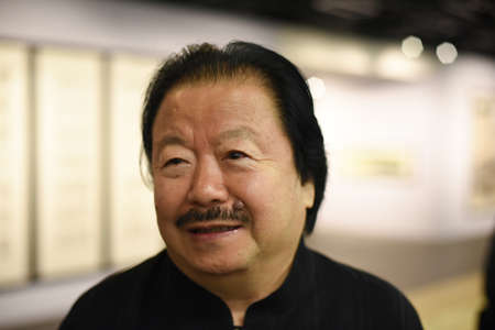 Saint-Petersburg, Russia - September 12, 2016: The richest Chinese artist Cui Ruzhuo to the opening of his exhibition in the Central Exhibition Hall on the background of his paintings.のeditorial素材