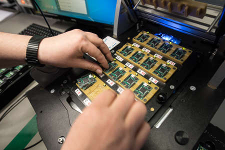 Saint-Petersburg, Russia - November 2, 2016: Manufacturer of automotive security systems Starline. Chips Printed Circuit Board at the final stage of production.のeditorial素材