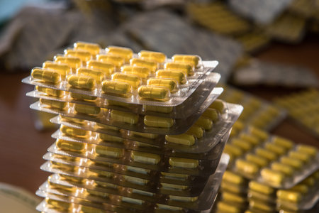 A large number of blisters capsules, tablets during the packaging production line for pharmaceutical...