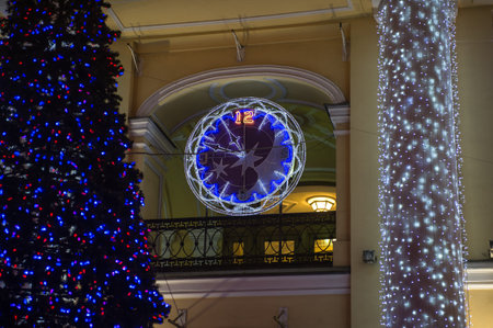 Decorated with multicolored diodes for Christmas clock on the wall of a building