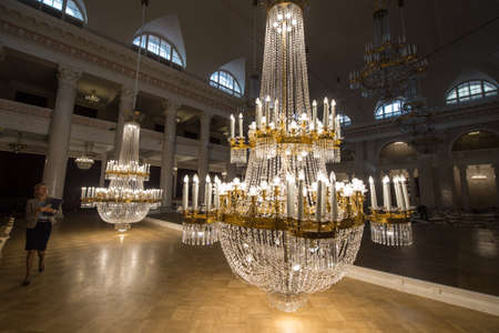 Saint-Petersburg, Russia - September 6, 2016: Huge crystal chandeliers in the large concert hall of the State Philharmonic Tchaikovsky lowered to the floor to remove dustのeditorial素材