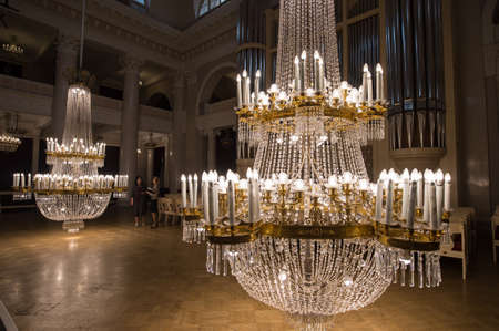 Saint-Petersburg, Russia - September 6, 2016: Huge crystal chandeliers in the large concert hall of the State Philharmonic Tchaikovsky lowered to the floor to remove dustのeditorial素材