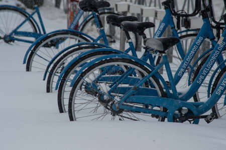 Saint-Petersburg, Russia - November 8, 2016: Snowfall in the city streets. Bicycles covered with snowのeditorial素材