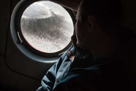 Saint-Petersburg, Russia - April 4, 2016: Crew Emergencies Ministry helicopter during flight on the study of ice conditions in the Gulf of Finland.のeditorial素材