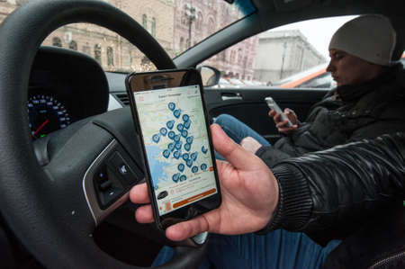 Saint-Petersburg, Russia - January 30, 2017: cars-sharing - the opening of a new service car rental per minute. Search free car parking with the mobile appのeditorial素材