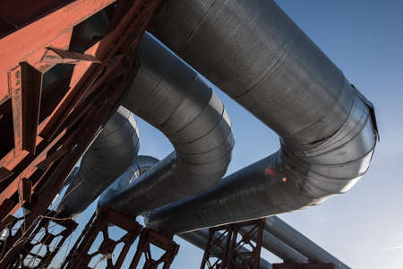 The pipeline in the form of a bridge over the earth, the conductive heat for heating the city district.の写真素材