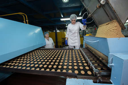Leningrad region, Russia - February 14, 2017: The production line of confectionery factory "Beloved Land". Cookies on the assembly line.のeditorial素材
