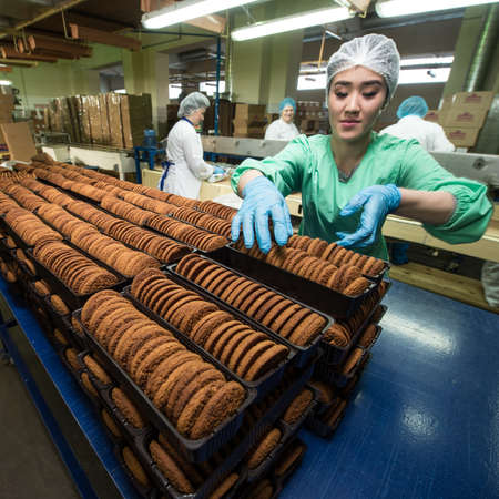 Leningrad region, Russia - February 14, 2017: The production line of confectionery factory "Beloved Land". Cookies on the assembly line.のeditorial素材