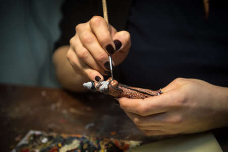 Saint-Petersburg, Russia - February 21, 2017: A small factory producing small batches pewter figurines.  painting the figure of a noblemanのeditorial素材