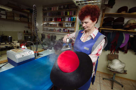 St. Petersburg, Russia - March 6, 2017: Factory for the manufacture of hats. The specialist does the final operation.のeditorial素材