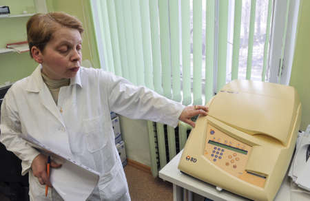 St. Petersburg, Russia - April 15, 2011: Laboratory of the hospital. Biochemist makes the analysis using an automatic biochemical analyzer.のeditorial素材