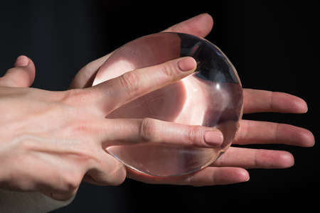 Demonstration of the properties of elasticity, softness, strength, reliability of silicone breast implant, used in plastic surgery to increase or enhance sexuality, aesthetic appeal of formsの写真素材