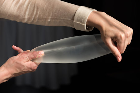 Demonstration of the properties of elasticity, softness, strength, reliability of silicone breast...