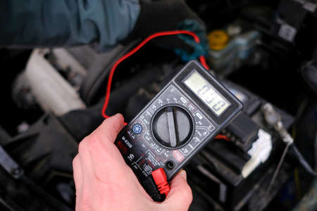 St. Petersburg, Russia - December 20, 2017: Due to the complexity of the car in winter, the battery is dead and the car does not start. An attempt to start the engine connecting the wires to the electrical network of another carのeditorial素材