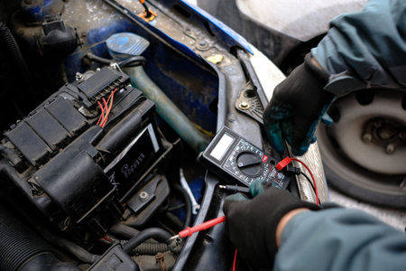 St. Petersburg, Russia - December 20, 2017: Due to the complexity of the car in winter, the battery is dead and the car does not start. An attempt to start the engine connecting the wires to the electrical network of another carのeditorial素材