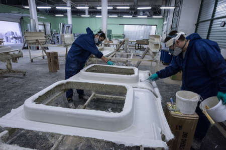 St. Petersburg, Russia - June 29, 2016: Painting workshop of the plant of transport engineering. Gluing and staining of facing panels of electric trains.のeditorial素材