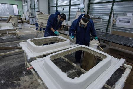 St. Petersburg, Russia - June 29, 2016: Painting workshop of the plant of transport engineering. Gluing and staining of facing panels of electric trains.のeditorial素材