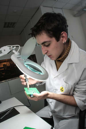 St. Petersburg, Russia - February 16, 2012: Electrotechnical College of Municipal Economy. Students study microcircuits for microelectronics classes.のeditorial素材