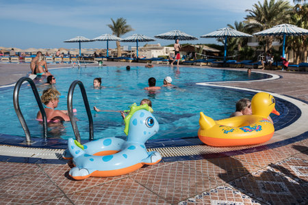 Hurghada, Egypt - December 2, 2014: Tourists are resting on the beach of the Red Sea. Outdoor swimming pool with fresh waterのeditorial素材