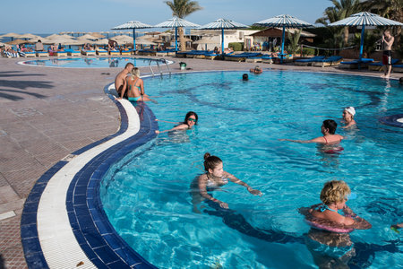 Hurghada, Egypt - December 2, 2014: Tourists are resting on the beach of the Red Sea. Outdoor swimming pool with fresh waterのeditorial素材