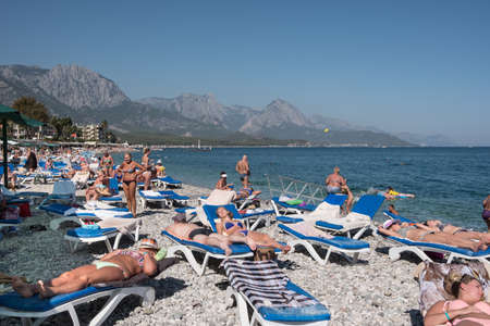 Kemer, Turkey - October 22, 2017: Tourists are resting on the beach of Kemer. View of the sea and mountains.のeditorial素材