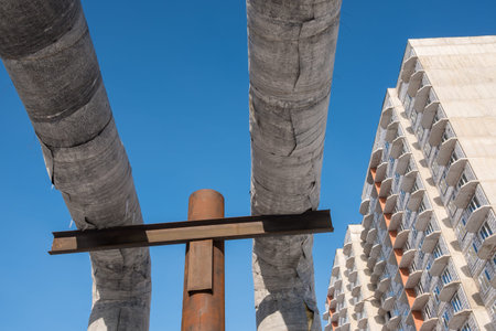 Laying of heat-insulated large diameter pipes for hot water supply during the construction of a residential area. Pipes are insulated with special materials. Are above the ground.の写真素材