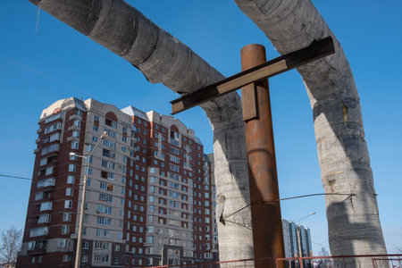 Laying of heat-insulated large diameter pipes for hot water supply during the construction of a residential area. Pipes are insulated with special materials. Are above the ground.の写真素材