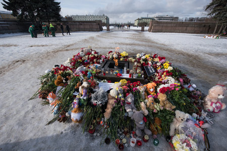St. Petersburg, Russia -28 March 2018: Flowers and children's toys are laid to eternal fire on the...