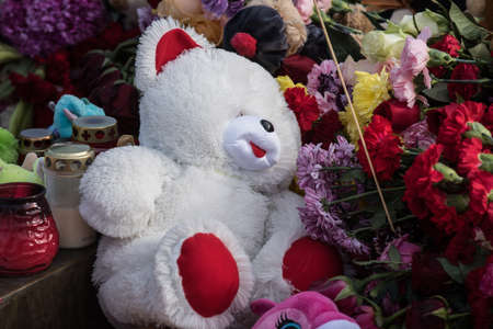 St. Petersburg, Russia -28 March 2018: Flowers and children's toys are laid to eternal fire on the Champ de Mars on the day of mourning and tragedy in Kemerovo, where people died in the Winter Cherry mallのeditorial素材