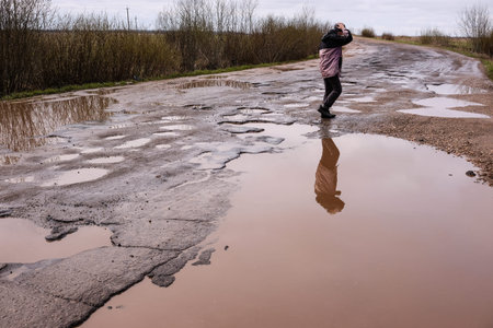Novgorod Region, Russia-May 1, 2018: The road of local importance in emergency condition with a lot...