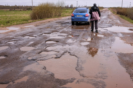 Novgorod Region, Russia-May 1, 2018: The road of local importance in emergency condition with a lot...