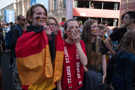 St. Petersburg, Russia - June 27, 2018: Fans watch a football match between Germany and Korea in the fan zone in the city center on the big screen, express their emotions.のeditorial素材