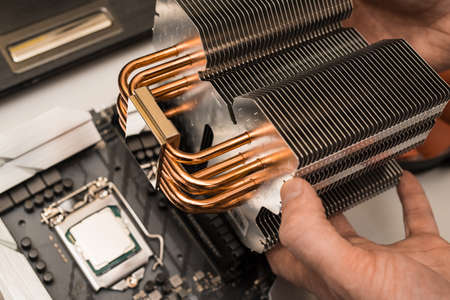 The process of installing a radiator at home with your own hands. The cooling system of the processor, consisting of a variety of plates for the discharge of excess heat from a multi-core processor.の写真素材