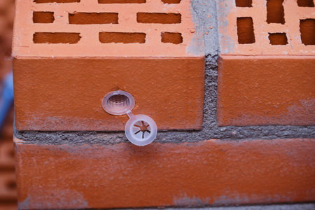 Red hollow brick. Brickwork. Installation of a chemical anchor using a special tool - resin, sleeve...