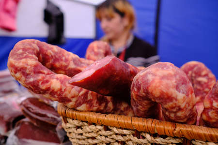 Leningrad Region, Russia - June 30, 2018: Sabantuy - the Peopleâs Tatar and Bashkir feast of the end of spring fieldwork. A woman sells smoked sausages.のeditorial素材