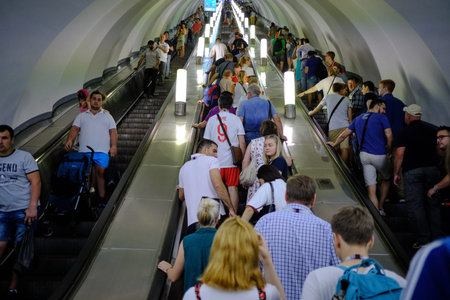 St. Petersburg, Russia - June 14, 2018: People on a subway escalator. Artificial light. Interior...