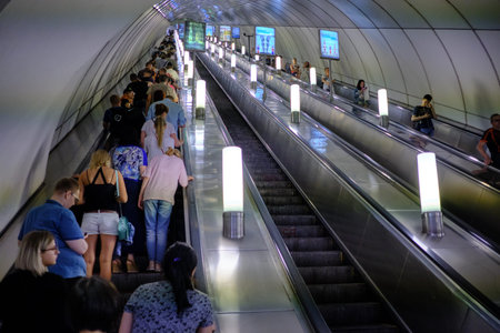 St. Petersburg, Russia - June 14, 2018: People on a subway escalator. Artificial light. Interior...